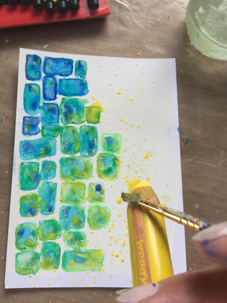 Creating yellow splatters on a card using Stabilo woodys.