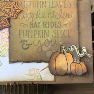 Closeup of tag for fall card that as been stamped with Newton Nook stamps and the background created with Ranger oxide inks.