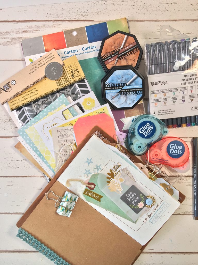 Supplies used to create a traveler's journal by Kerry Engel featuring Momenta, Clearsnap and Glue Dots