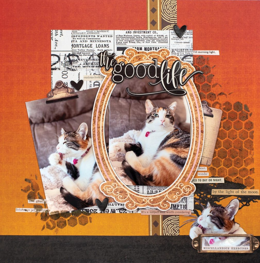 The Good Life scrapbook layout by Desiree Saskiw featuring a cozy cat design with layered papers, textured honeycomb stenciling, and warm autumn tones.